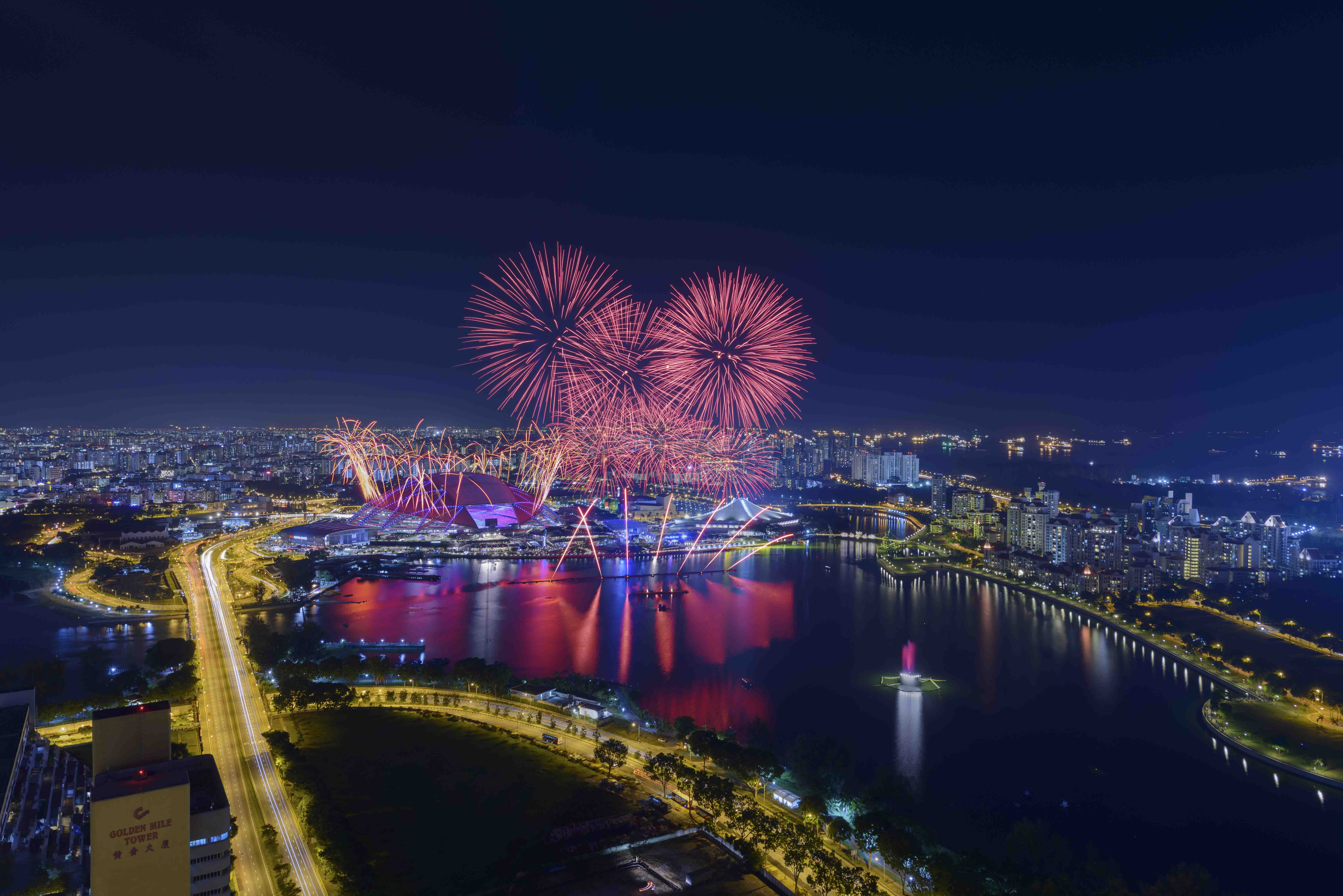 Fireworks over the skyline during a night celebration.